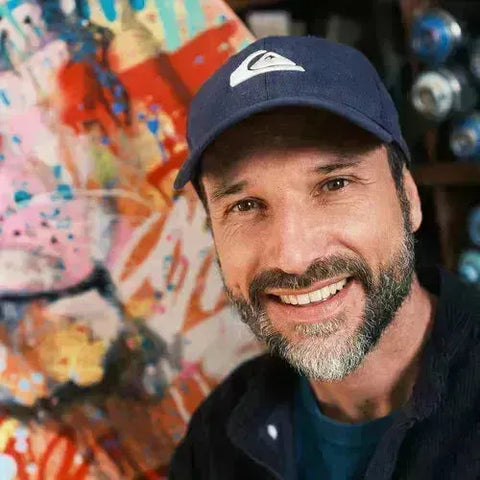 Smiling middle-aged man in navy blue baseball cap from Vincent Richeux collection