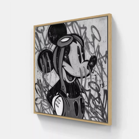 A framed print of a cartoon character with graffiti on it