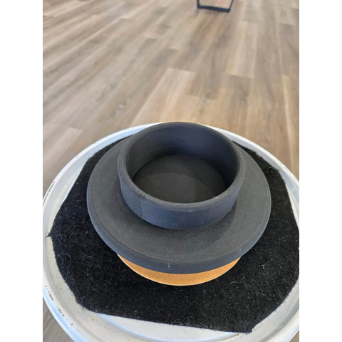 Ceramic or pottery vessel with a wide brim and layered circular design in gray, black, and orange tones.