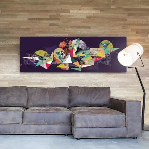 A couch sitting in front of a wall with a painting on it