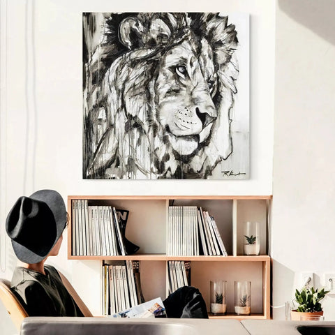 A man sitting at a desk with a painting on the wall