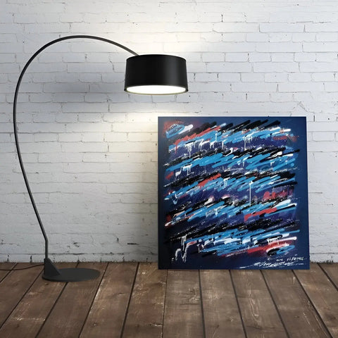 A large black and blue abstract painting on a white brick wall