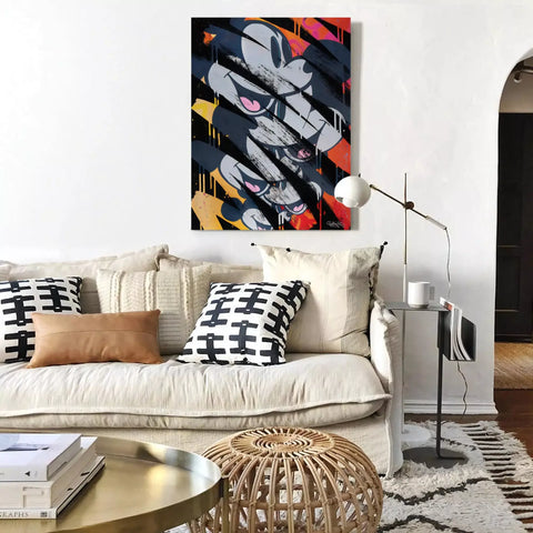 A living room with a couch, coffee table and a painting on the wall