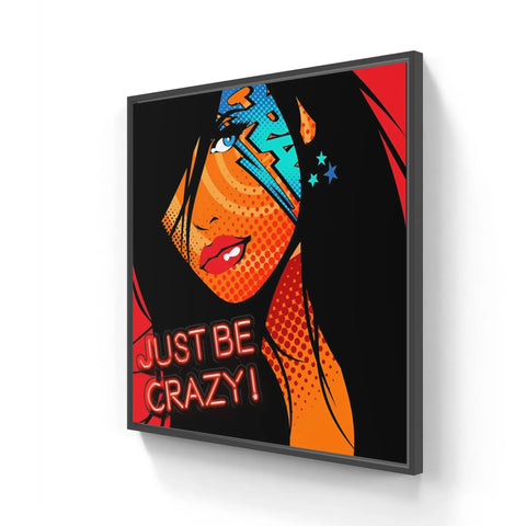 A framed canvas with a woman’s face and the words just crazy