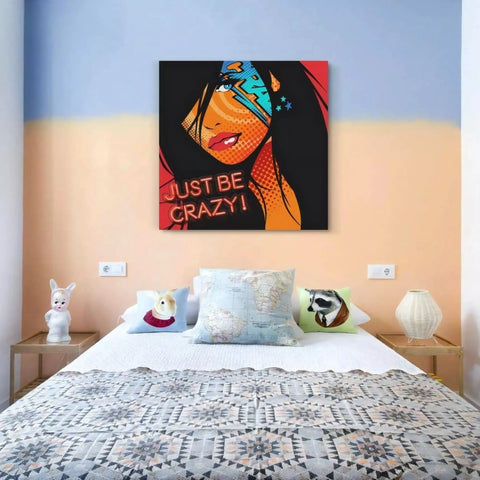 A bed with a painting on the wall