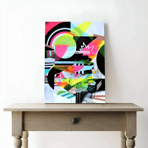 Brightly colored abstract painting on a wooden table in a white room