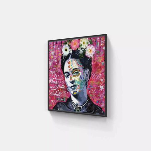 A framed canvas with a painting of a woman with flowers on her face