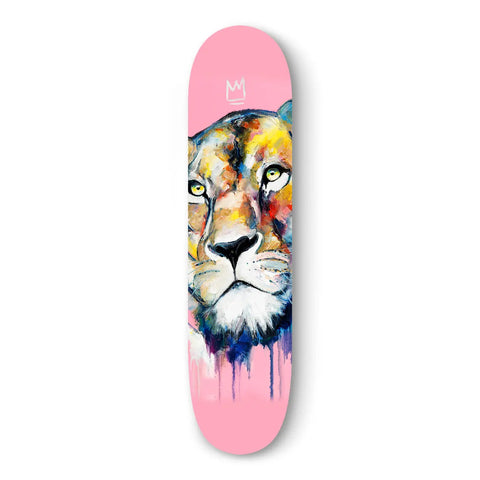 Colorful lion face painted on a pink skateboard deck.