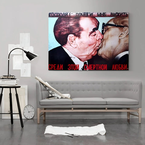 A couch with a painting of a man kissing a woman