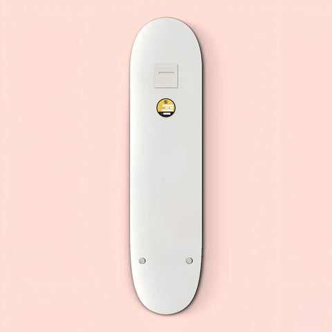 White skateboard deck with a small circular yellow emoji logo.