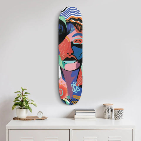 Colorful abstract art painted on a skateboard deck mounted vertically as wall decor.