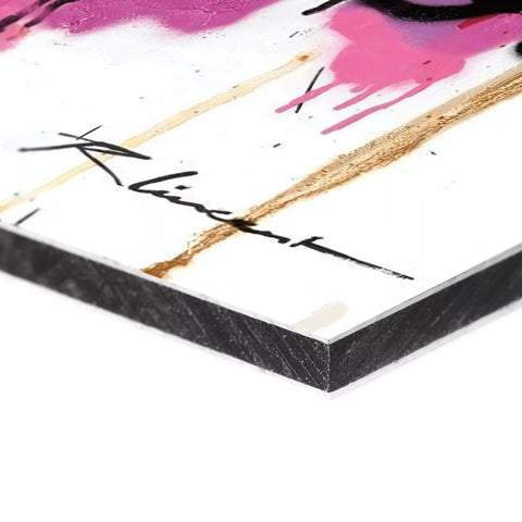 Corner of a canvas or art print with abstract pink and gold brushstrokes and a signature.