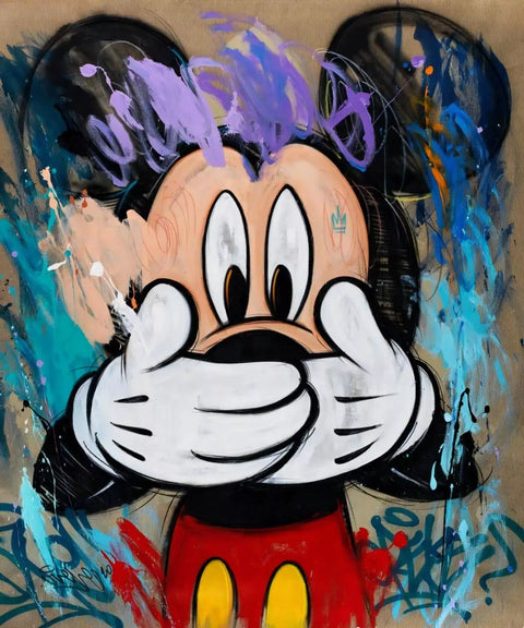 Mickey mouse painting on a wall with graffiti on it