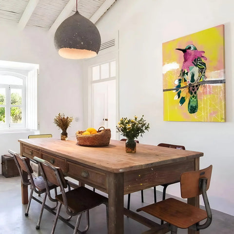 Wooden dining table with chairs in a bright interior setting.