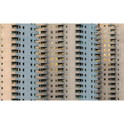 A tall building with many windows and bales