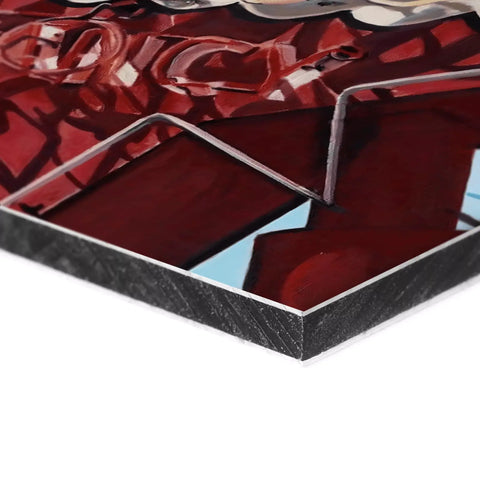 Abstract metal wall art with intertwining red ribbons or shapes.