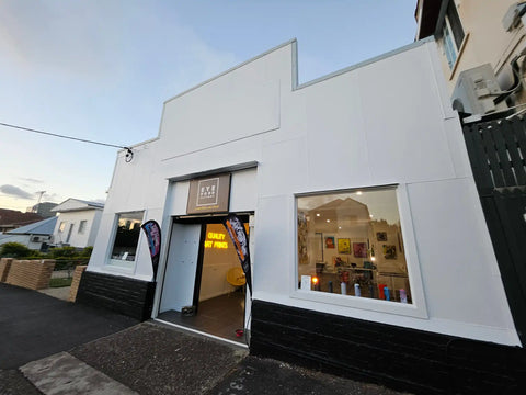 White-painted storefront with a stepped roofline and large display window.